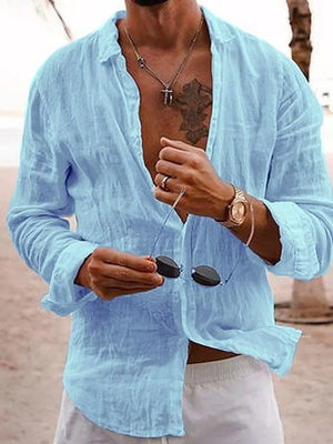 Relaxed light blue linen button-front shirt with spread collar and long sleeves.