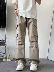 Khaki wide-leg cargo pants with multiple flap pockets and adjustable ankle cuffs.
