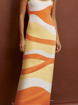 Geometric knit maxi slip dress in orange, yellow, and white abstract wavy stripes.