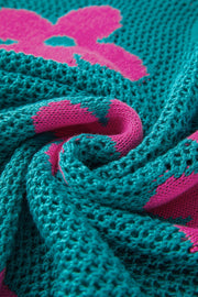 Openwork floral intarsia sweater in teal with pink bloom pattern, acrylic knit detail.