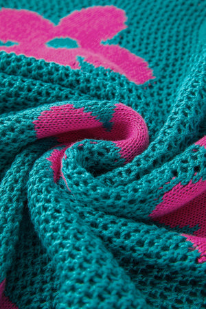 Openwork floral intarsia sweater in teal with pink bloom pattern, acrylic knit detail.
