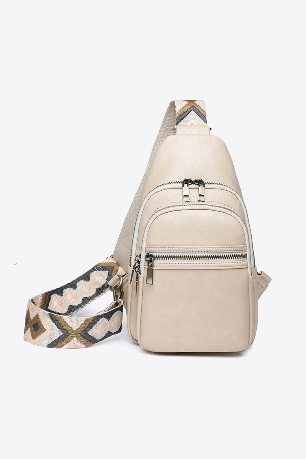 Cream geometric strap sling bag with multiple zippered pockets.