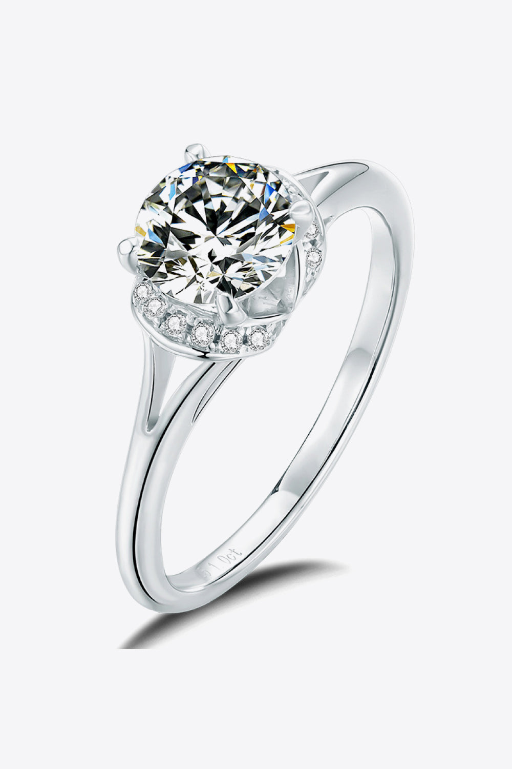 Split shank halo moissanite ring in silver with a round cut center stone and pave accent stones.