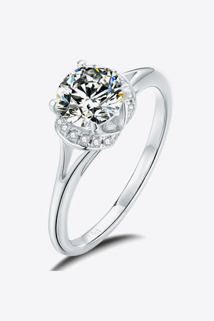 Split shank halo moissanite ring in silver with a round cut center stone and pave accent stones.