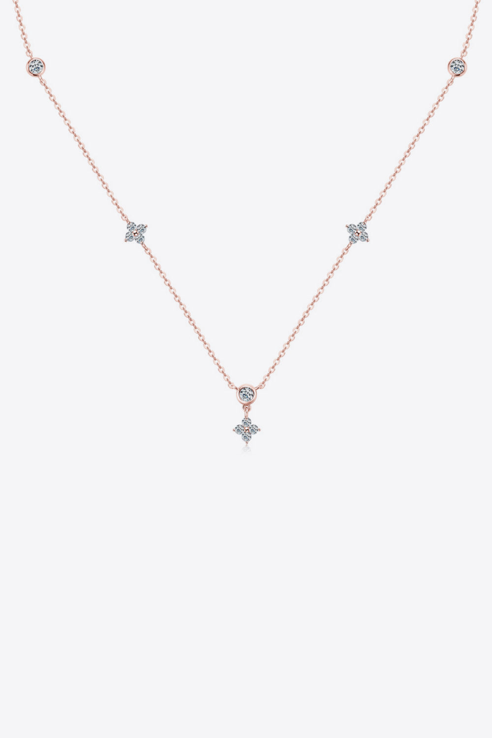 Rose gold necklace with scattered diamond clusters and a central diamond pendant.