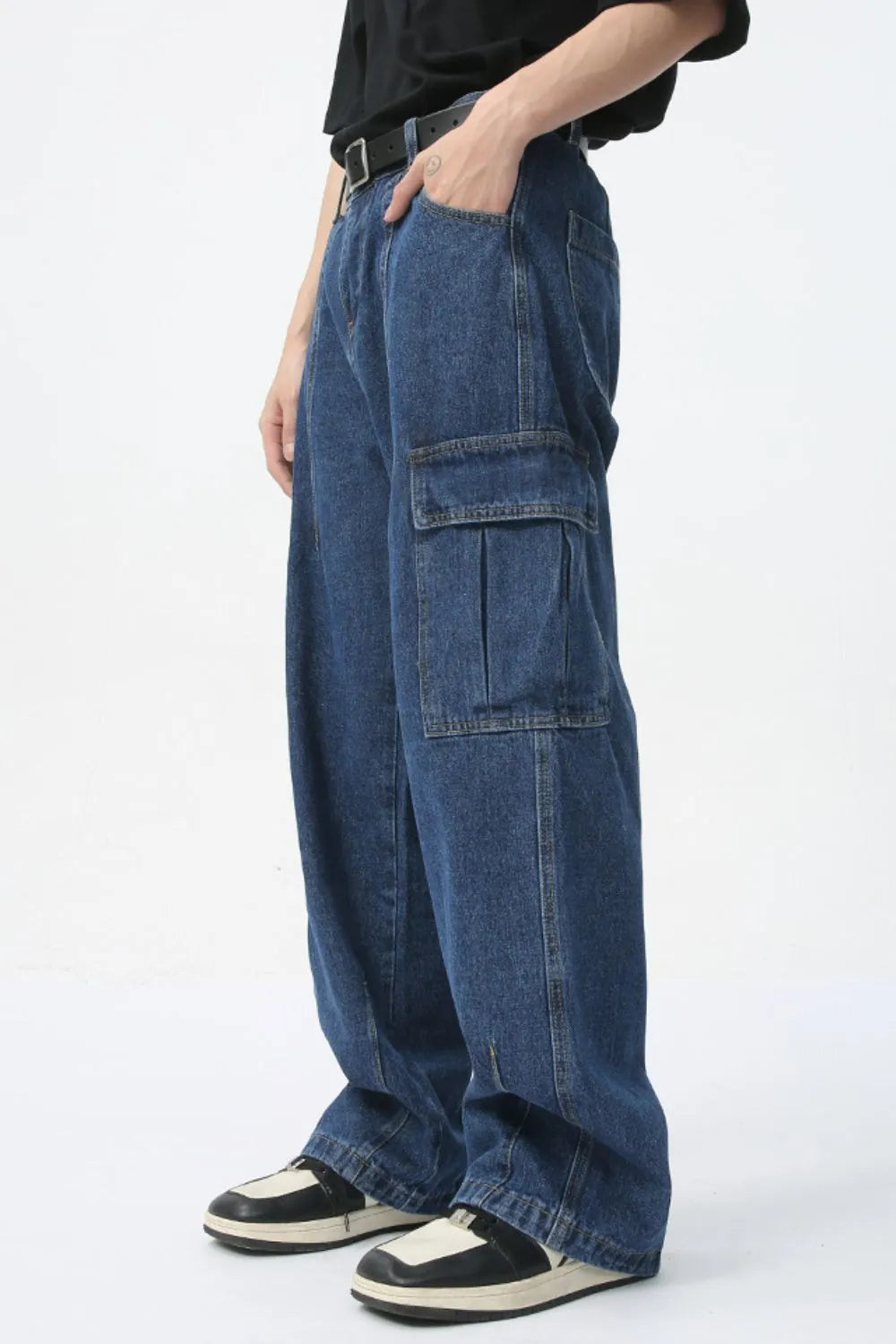 Wide-leg denim cargo pants in dark wash with pleated cargo pockets.