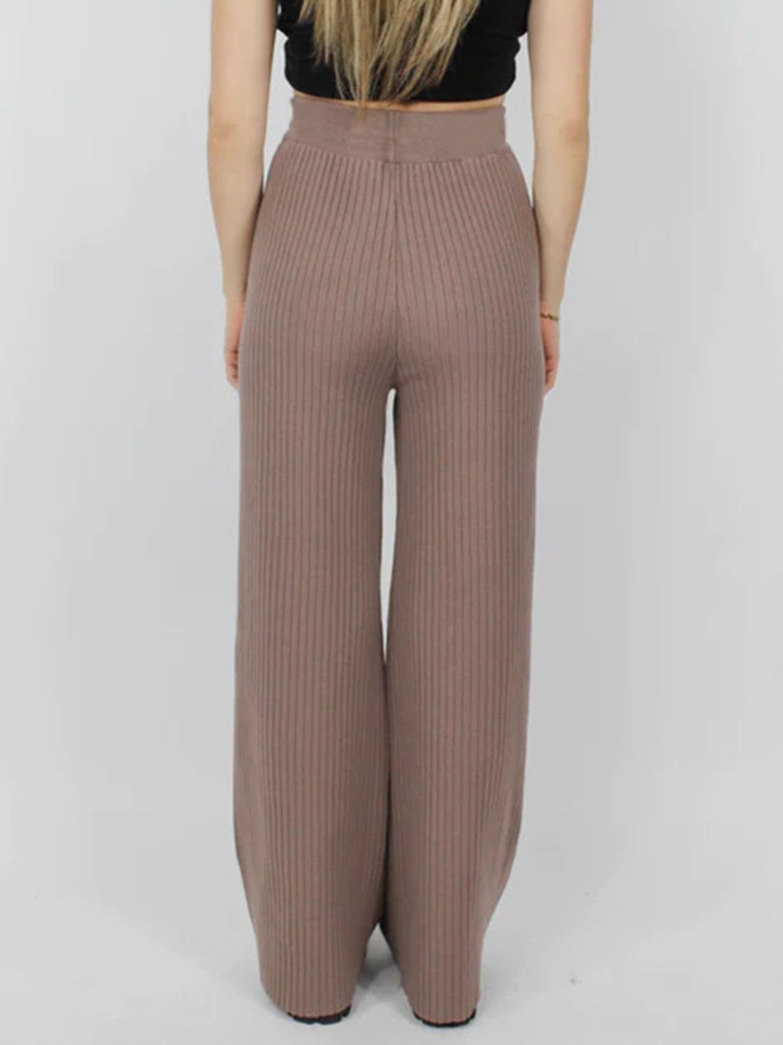 Luxe ribbed knit palazzo trousers in taupe, featuring a wide leg and high waist.