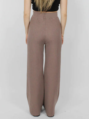 Luxe ribbed knit palazzo trousers in taupe, featuring a wide leg and high waist.