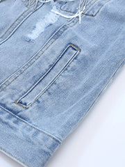 Light wash denim trucker jacket with distressed details, sequin fringe, and pocket.