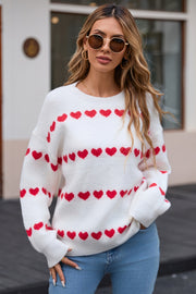 White knit pullover sweater with red heart stripes and crew neck.