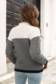 Chevron block mock neck knit sweater in black and white acrylic with herringbone sleeves.