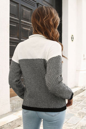Chevron block mock neck knit sweater in black and white acrylic with herringbone sleeves.