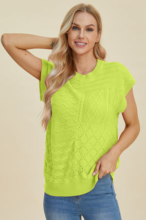 Lime green knit patchwork top with cable and diamond textures, short sleeves, and crew neck.