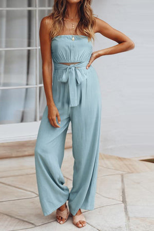 Light blue bandeau tie-waist wide-leg jumpsuit with a cropped bodice and flowing pants.