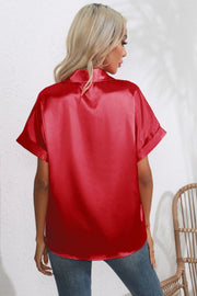 Scarlet satin blouse with cuffed short sleeves and a button-down collar.