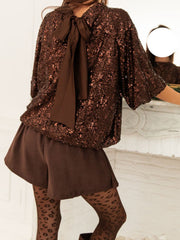 Dazzling sequin blouse in dark brown with a tie-back detail and short sleeves.