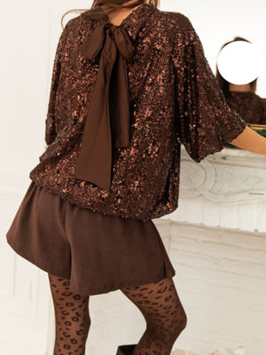 Dazzling sequin blouse in dark brown with a tie-back detail and short sleeves.