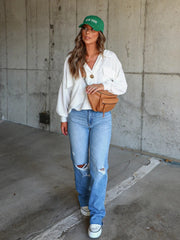 White textured boxy utility shirt jacket with button details and a collared neckline.