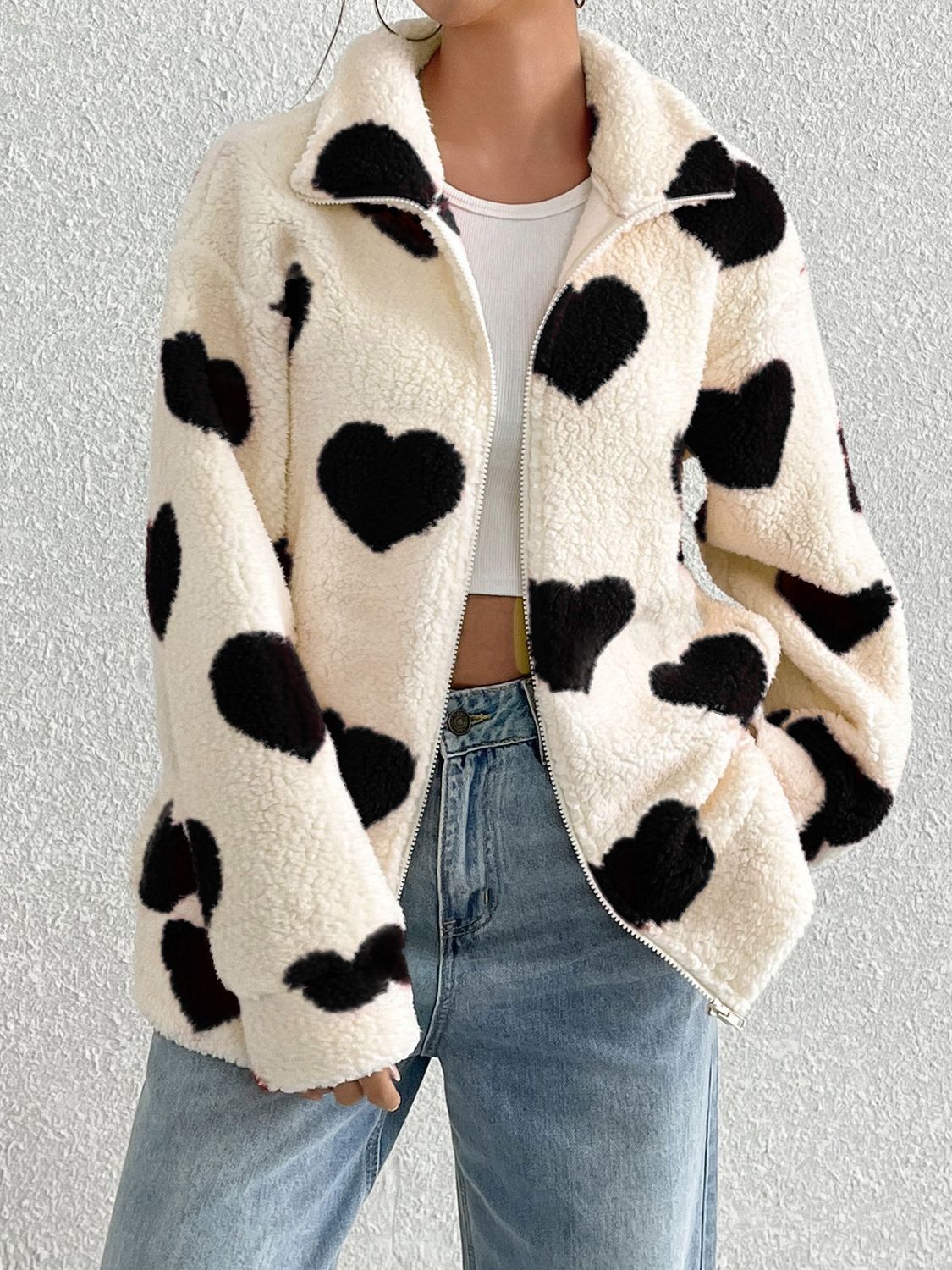Heart print sherpa zip-up jacket with a collared neckline.