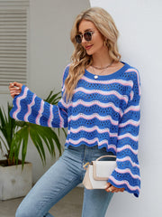 Blue crochet crop sweater with pink and white wavy stripes, bell sleeves, and scalloped hem.