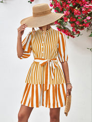 Vertical stripe shirred waist dress in gold with tie belt and tiered skirt.