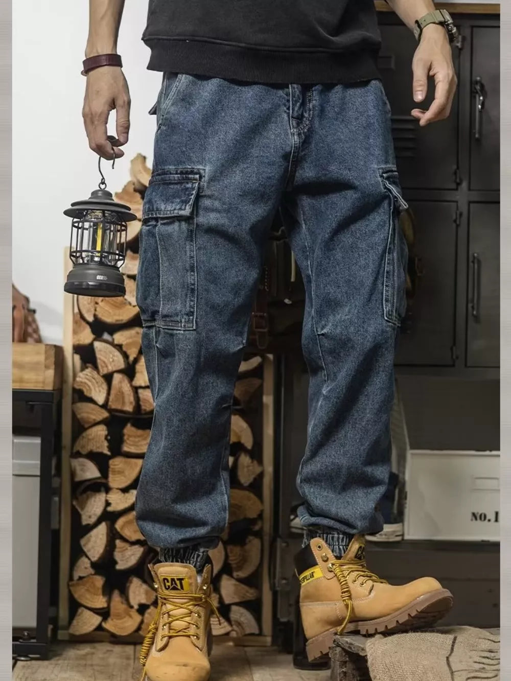 Men's vintage wash denim cargo jeans with elastic cuffs and multiple pockets.