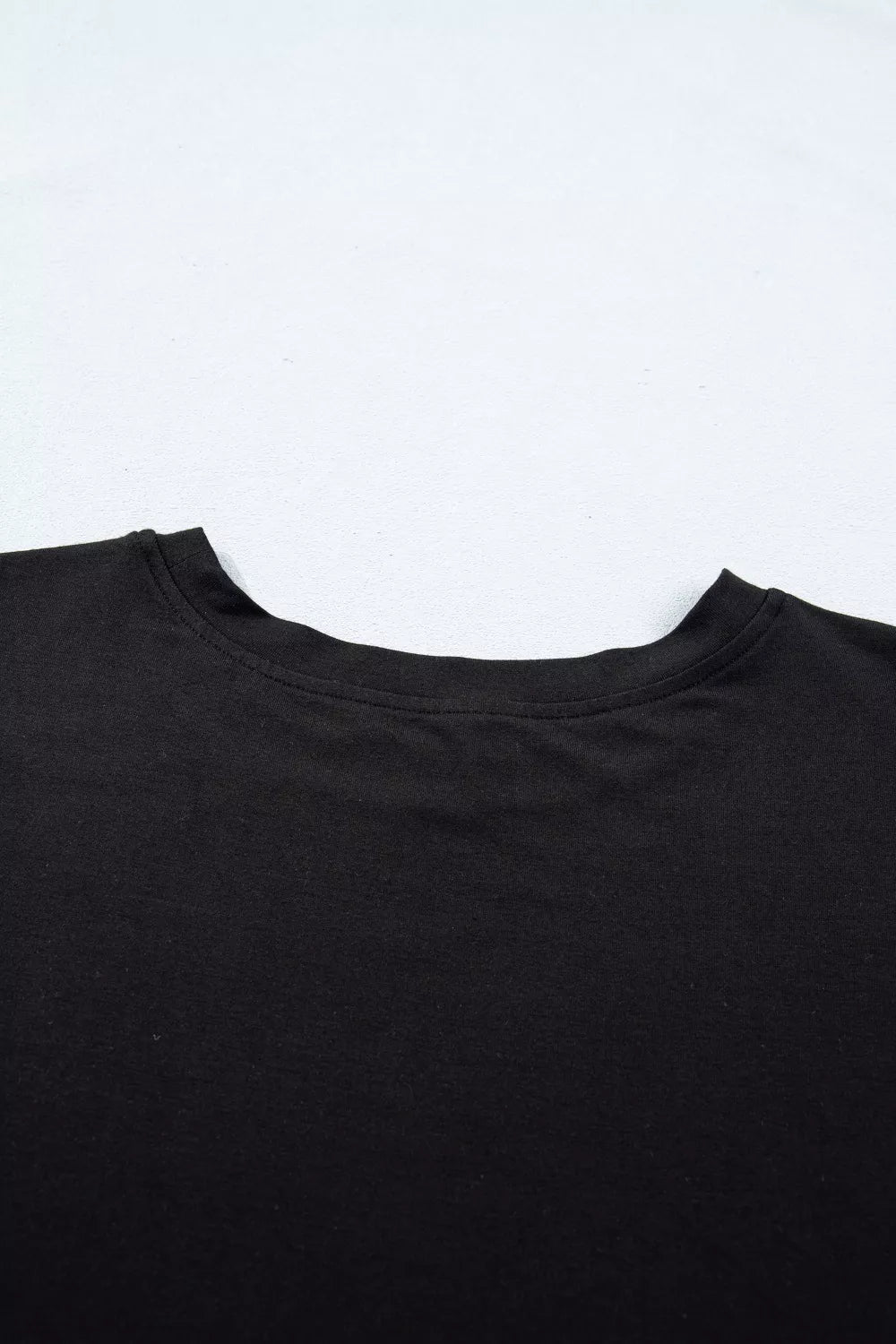Black crew neck t-shirt detail, casual women's apparel