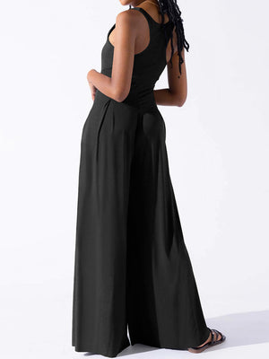 Black square neck palazzo jumpsuit with wide legs and a sleeveless design.