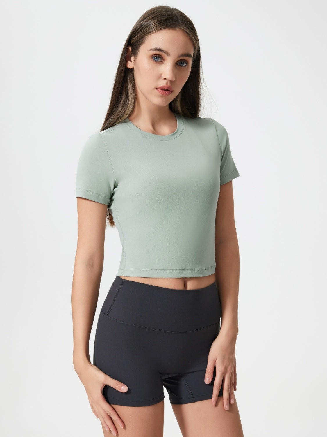 Sage cropped performance crew neck top with short sleeves.