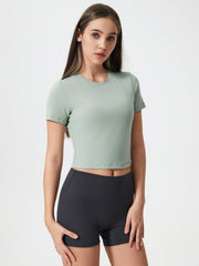 Sage cropped performance crew neck top with short sleeves.
