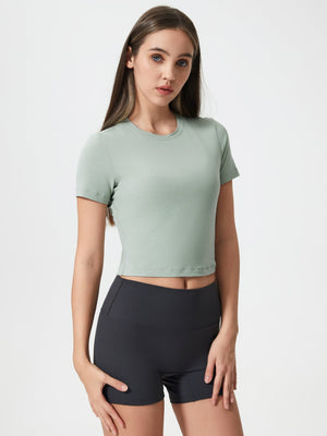 Sage cropped performance crew neck top with short sleeves.