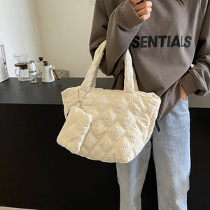 Quilted ivory shopper tote bag with matching coin purse and chain detail.