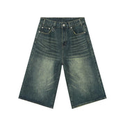 Wide-leg denim culottes in a distressed blue wash with a high waist.