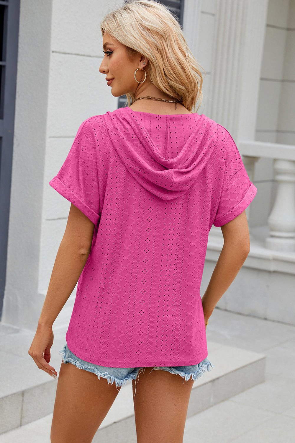 Hot Pink perforated henley hooded tee with short sleeves and a relaxed fit.