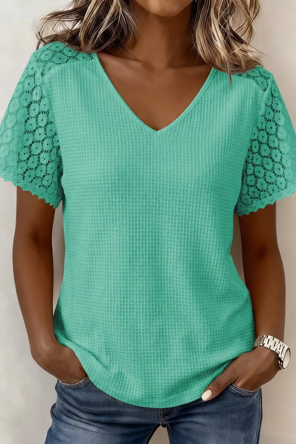 Teal waffle knit V-neck shirt with short lace sleeves and scalloped trim.
