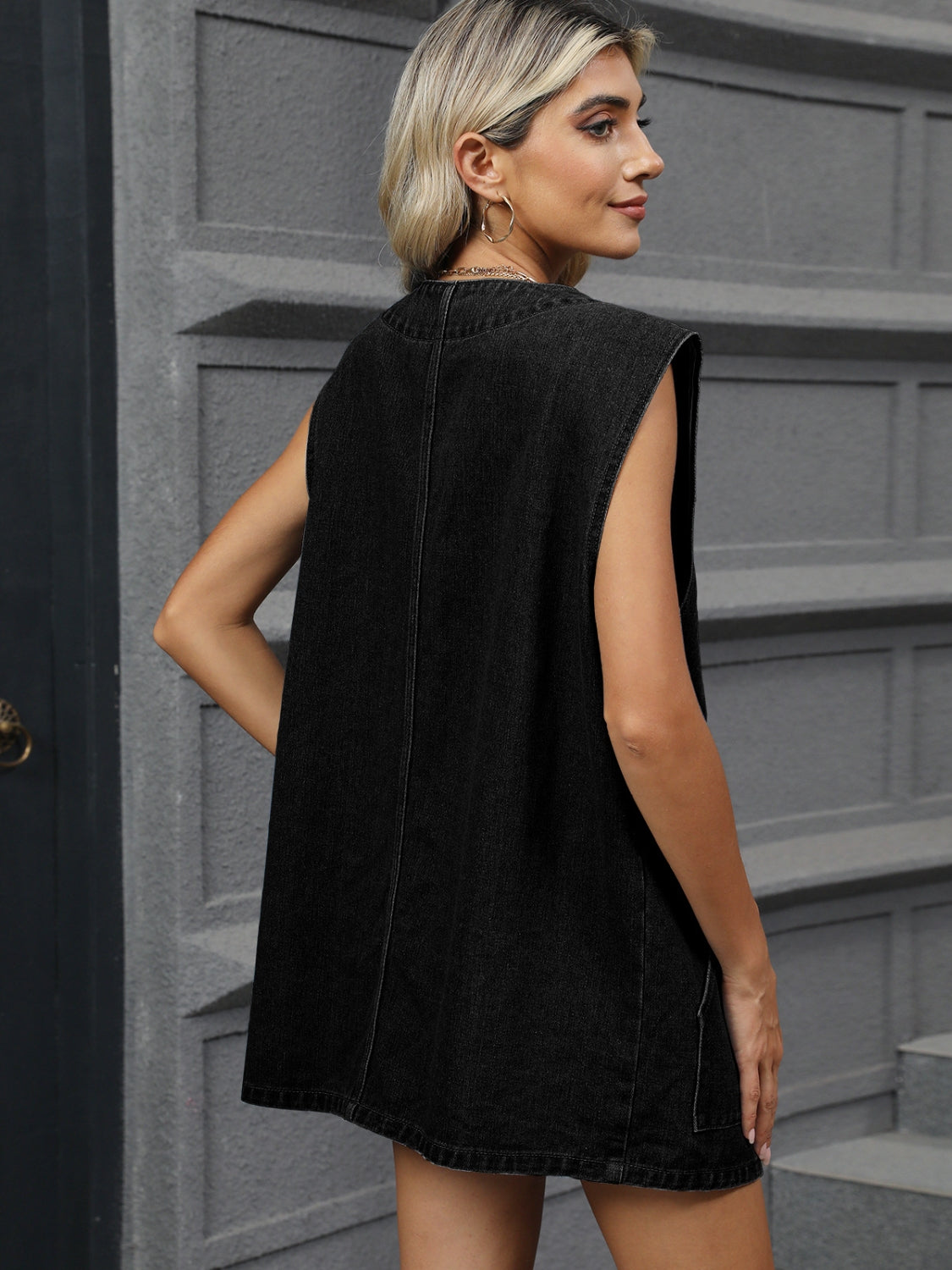 Black denim vest with button front and sleeveless design