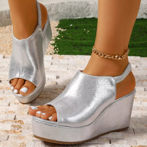 Sleek silver high heel wedge sandals with peep toe and elastic slingback strap.