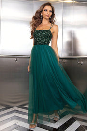 Green sequin bodice tulle maxi dress with spaghetti straps and a flowing skirt.