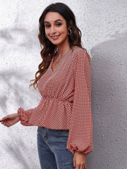 Gingham peplum blouse with gathered waist in red and white, featuring a V-neck and balloon sleeves.