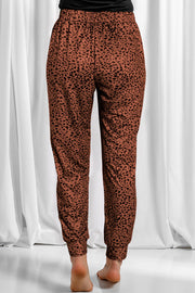 Brown leopard print jogger trousers with elastic waistband and cuffed ankles.