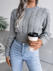 Dark gray acrylic cable knit cropped mock neck sweater with cuffed sleeves and hem.