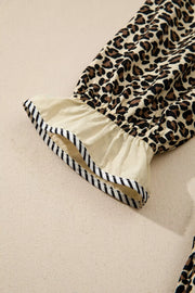 Leopard print mini dress with ruffled sleeve and black and white striped trim
