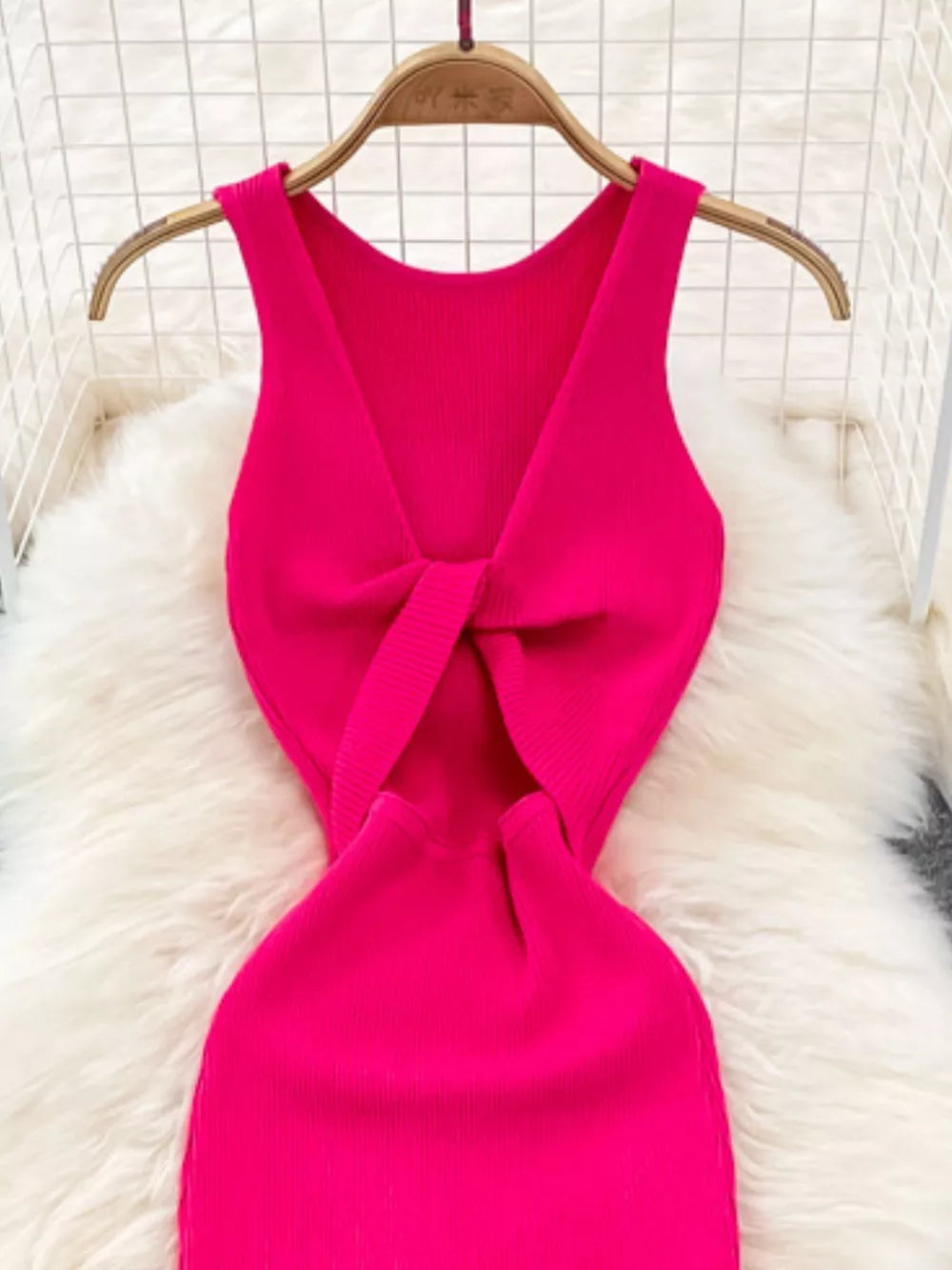 Rose Red ribbed knit midi dress with a knot-back cutout detail.