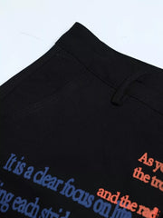 Black cargo pants with blue and orange text print detail