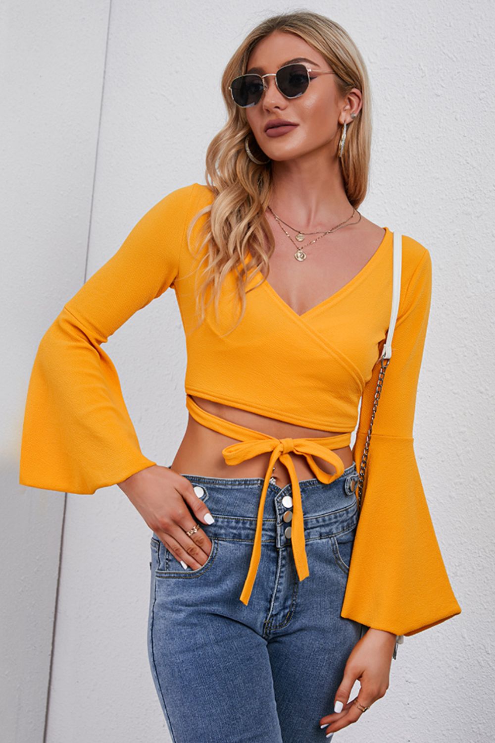 Pumpkin wrap tie bell sleeve crop top with v-neck and tie waist detail