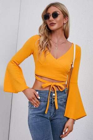 Pumpkin wrap tie bell sleeve crop top with v-neck and tie waist detail