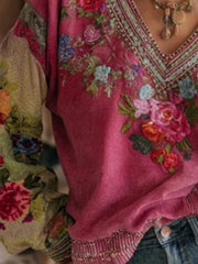 Embroidered deep rose V-neck blouse with floral detail and contrast printed sleeves.