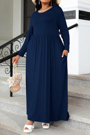 Navy long sleeve maxi dress with gathered waist and pockets.