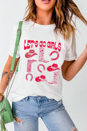 White graphic t-shirt with pink western boots, hats, and horseshoes and "Let's Go Girls" text.