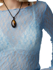 Light blue lace blouse with scalloped neckline and long sleeves, worn with a pendant necklace.
